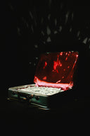 Suitcase filled with money and red fabric