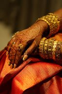 Hands adorned with henna and gold jewelry
