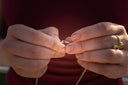 Woman fastens a necklace clasp with her hands