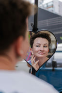 Woman looking in heart-shaped mirror