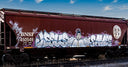Graffiti art covers a brown train car
