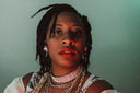 Woman with dreadlocks wearing layered necklaces