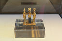 Three golden ancient egyptian figurines on display