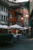 Colorful buildings line a european street with outdoor seating.
