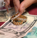 Diamond rings resting on us dollar bills