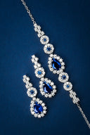 Sparkling blue gemstone jewelry set on dark blue background