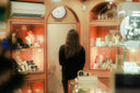 Woman browsing jewelry in a brightly lit store
