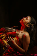 Woman with ornate jewelry and body paint