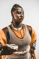 Woman with elaborate jewelry and face paint