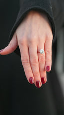 Woman's hand with a large diamond engagement ring.