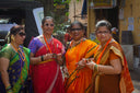 Four women in colorful saris and jewelry