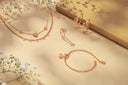 Rose gold jewelry set with delicate floral accents
