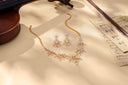 Diamond necklace and earrings with musical notes.