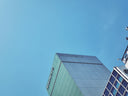 Modern buildings with blue windows against a clear sky.
