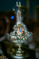 Ornate silver vessel with a crown and coat of arms