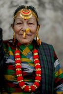Smiling elderly woman wearing traditional colorful clothing and gold jewelry