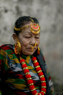 Elderly woman in traditional dress with ornate gold jewelry