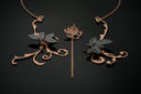 Rose gold and dark metal jewelry pieces with floral and leaf motifs