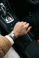 Silver-toned rectangular watch with white dial and roman numerals on stainless steel bracelet in art gold jewelry trends