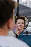 Woman looking in heart-shaped mirror