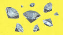 Faceted silver-gray diamonds of varying sizes scattered on a vibrant yellow background for fine jewelry and 18k gold settings