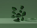 A glossy dark green glass plant sculpture with smooth rounded leaves complements fine jewelry and art gold collections