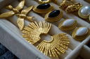 Gold-toned bird-shaped clip-on earrings with detailed feather textures and polished metallic finish in fine jewelry style