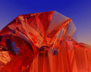 A close up of a red object with a blue sky in the background