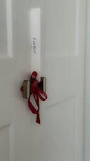 A sleek white cartier box with a red ribbon and elegant script logo, highlighting fine jewelry for modern collectors.