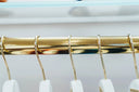 Gold rack with white hangers for stunning 18k gold fine jewelry