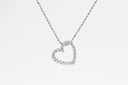 A delicate silver diamond heart pendant necklace with sparkling diamonds and matching ball chain in fine jewelry.
