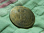 A close up of a coin on a green cloth