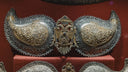 Ornate antique metalwork with paisley motifs