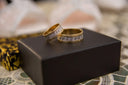 two wedding rings sitting on top of a black box