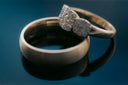 a couple of wedding rings sitting on top of a table