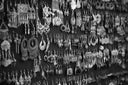 a black and white photo of a wall of earrings