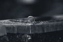silver ring on black concrete surface