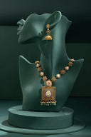 A mannequin with a necklace and earrings on display