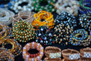 A table topped with lots of different types of bracelets
