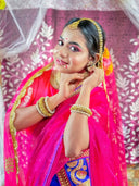 A beautiful bride adorns herself with jewelry.