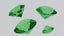 A group of green diamonds sitting on top of a table