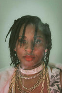 Exquisite royal jewels: woman in layered art gold jewelry and pink choker