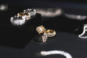A gold ring with a square pave-set diamond face and a diamond encrusted band featured in And Royal Legacy fine jewelry.