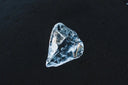 A translucent faceted ice crystal reflecting light symbolizes the rarity and beauty prized in fine jewelry and 18k gold designs