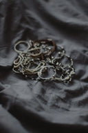 Delicate beaded fine jewelry necklaces in white, silver, black tones