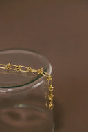 Stunning 18k gold chain with charm on glass jar rim