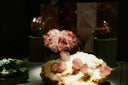 A cluster of translucent pink crystals with a rough base featured in fine jewelry and art gold collections on cursed gems