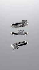 Three elegant platinum engagement rings with square-cut diamonds showcased at an Everett jewelry store.