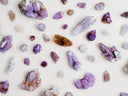 A collection of naturally occurring purple and clear quartz crystals featured in art gold and fine jewelry designs