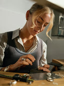A woman wearing a silver chain necklace with small links showcasing fine jewelry care for 18k gold collections